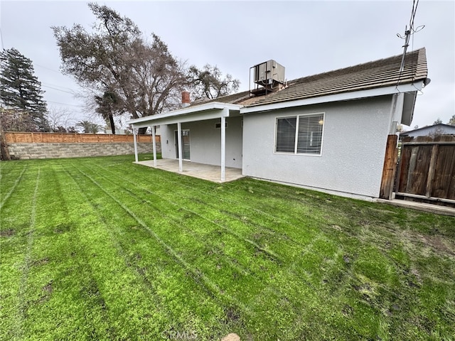 rear view of house with a yard, a patio, and central air condition unit