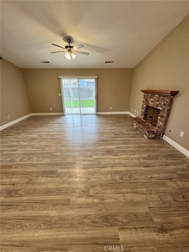 unfurnished living room featuring hardwood / wood-style floors and ceiling fan