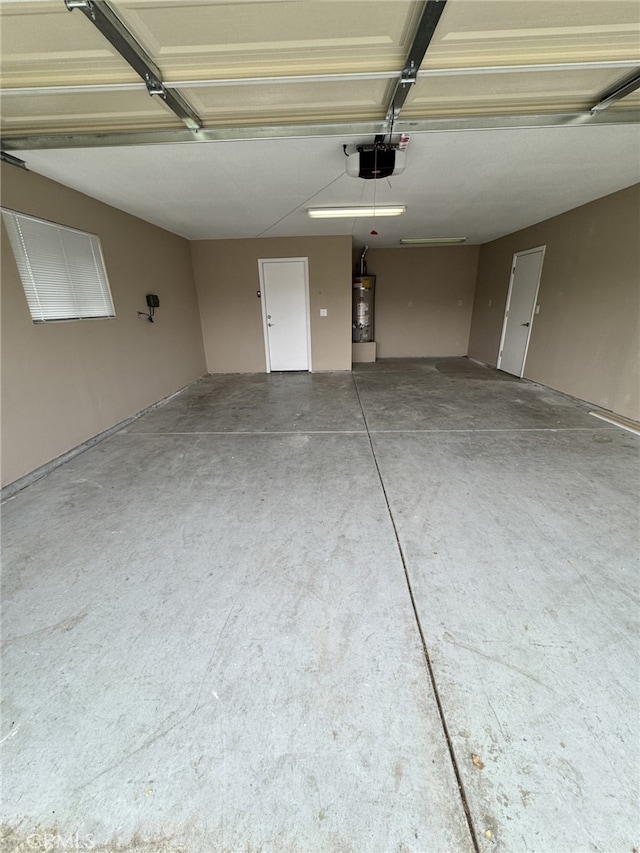 garage with a garage door opener and water heater