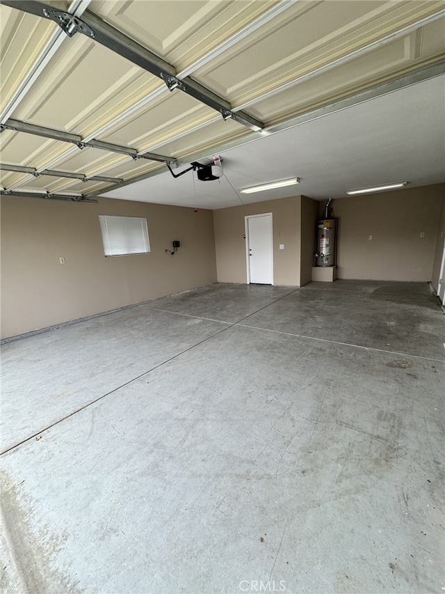 garage featuring a garage door opener and water heater