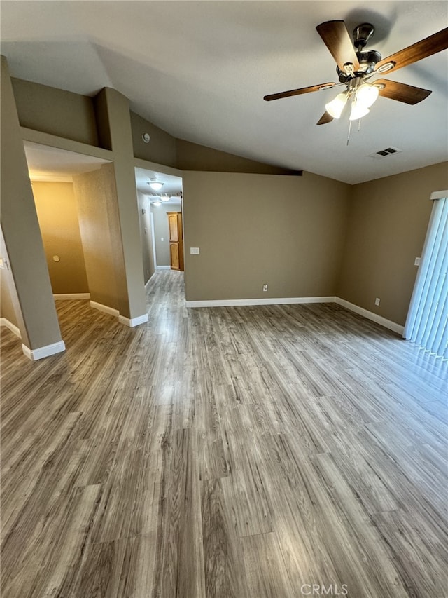 unfurnished living room with hardwood / wood-style flooring, lofted ceiling, and ceiling fan