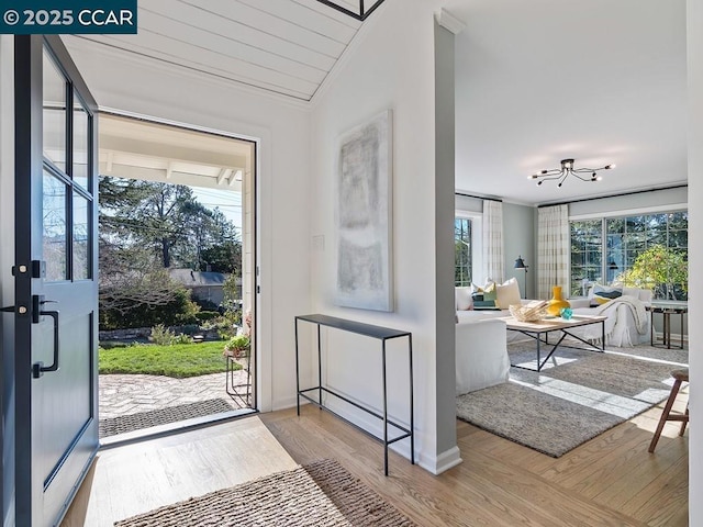 foyer entrance with lofted ceiling and light hardwood / wood-style flooring