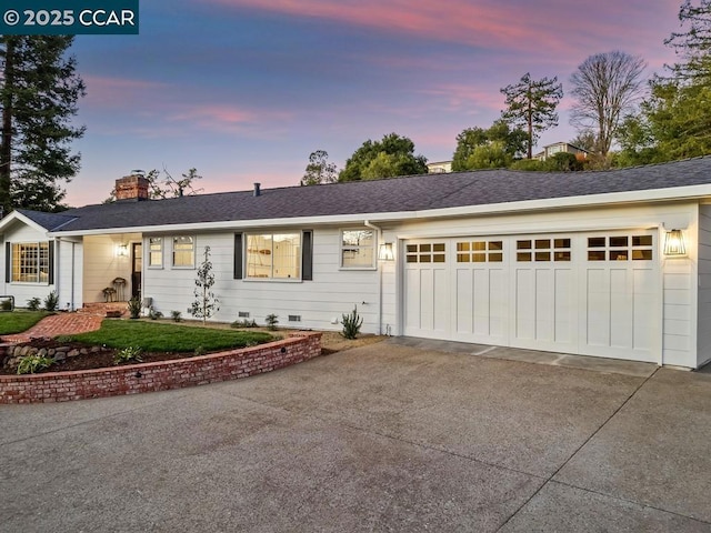 ranch-style home featuring a garage