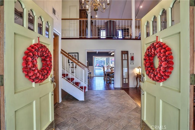 foyer with a chandelier and a high ceiling