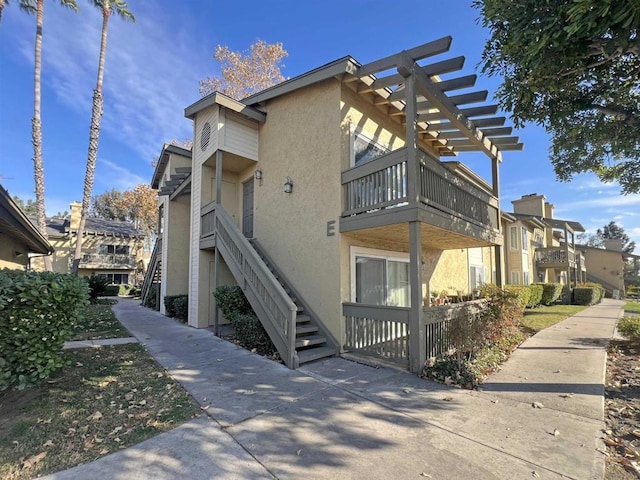 view of property exterior featuring a pergola