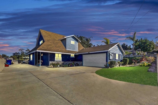 view of front of home featuring a garage and a yard