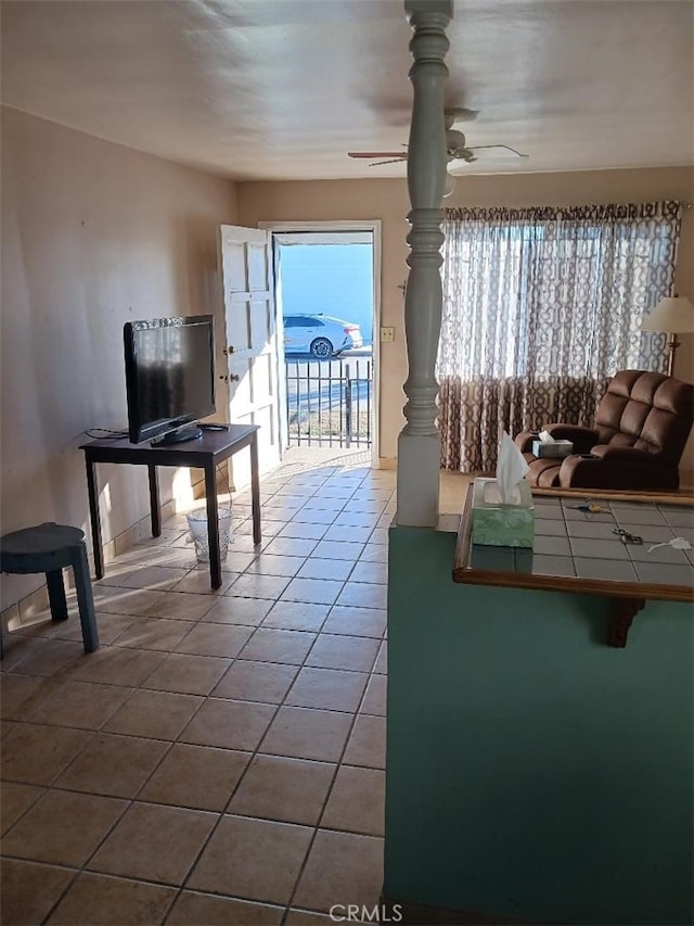 unfurnished living room with ceiling fan and tile patterned floors