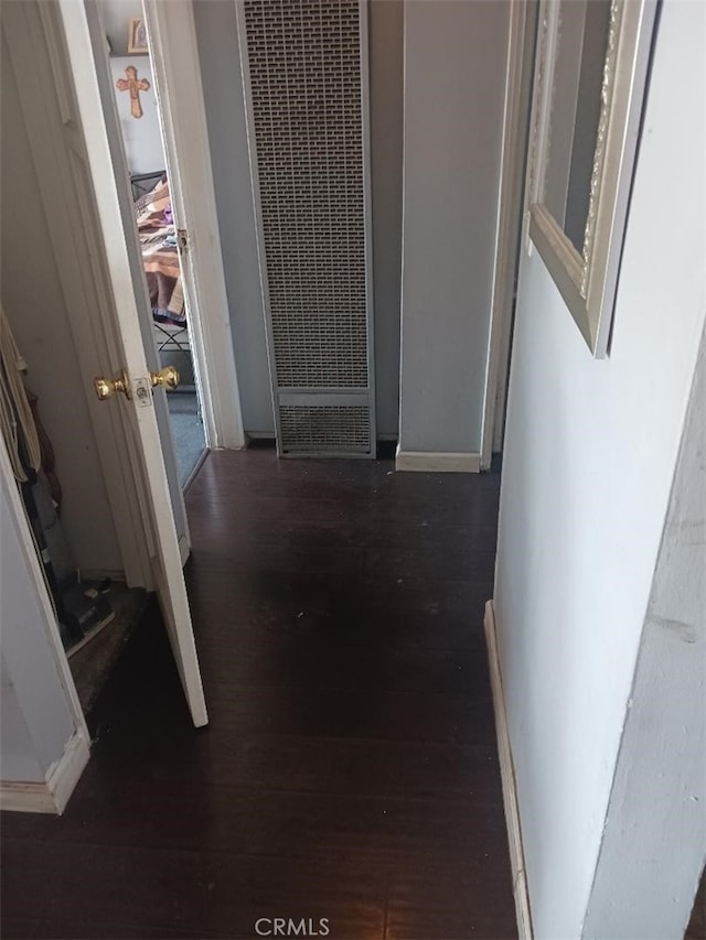 hallway with dark wood-type flooring