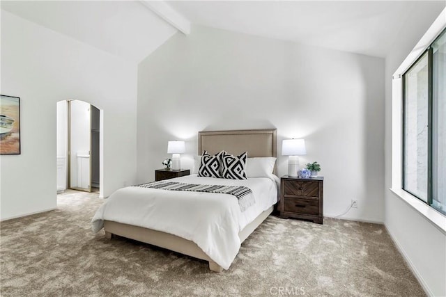 bedroom featuring high vaulted ceiling, beam ceiling, and light colored carpet