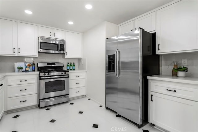 kitchen featuring stainless steel appliances and white cabinets