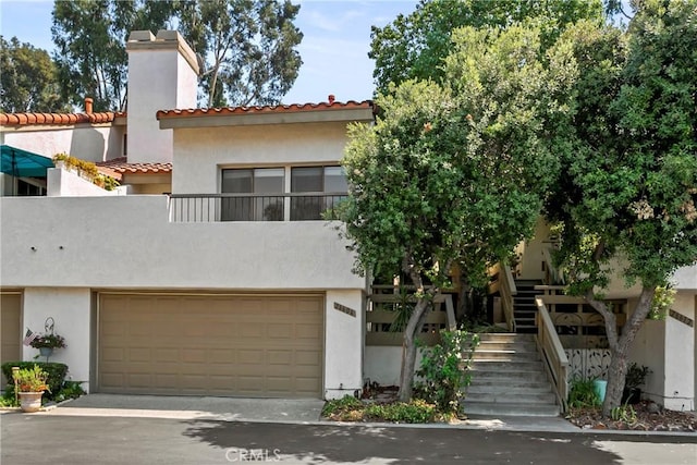 view of front facade with a garage and a balcony