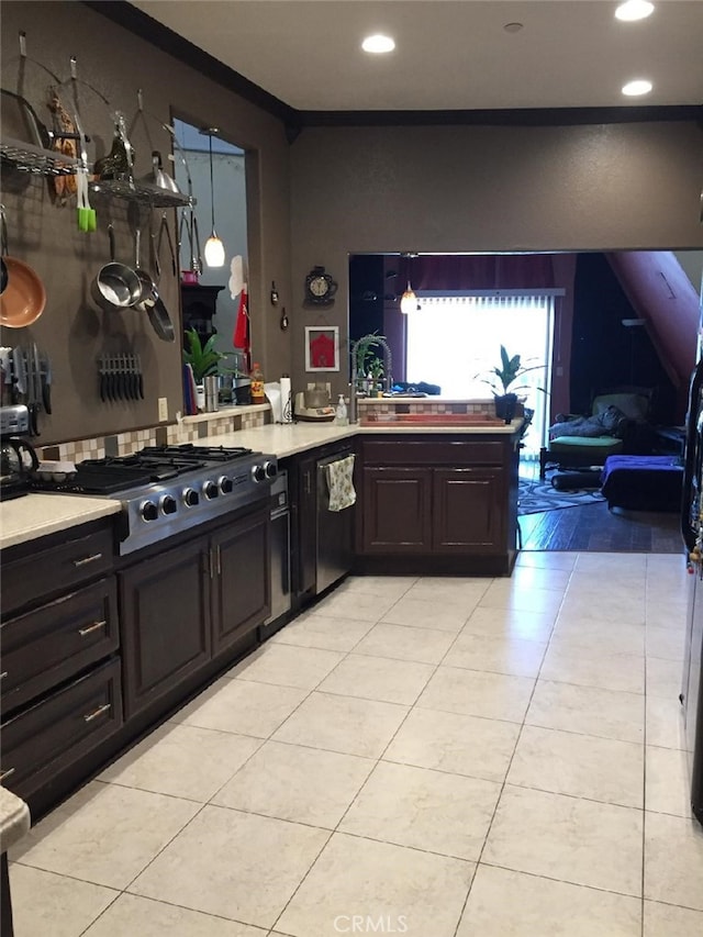 kitchen with light tile patterned floors, dishwasher, light countertops, and stainless steel gas stovetop