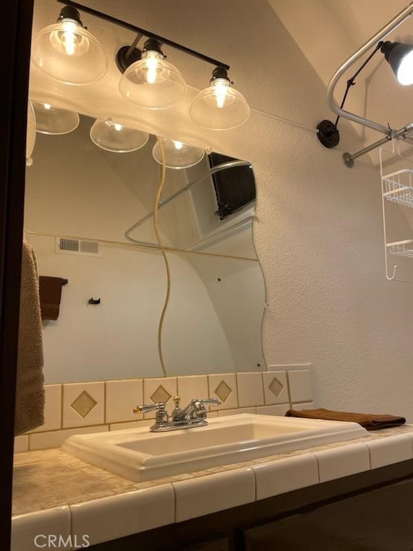 bathroom with visible vents and vanity