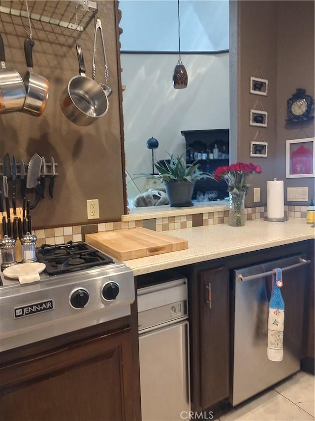 kitchen featuring light countertops, tasteful backsplash, and stainless steel appliances