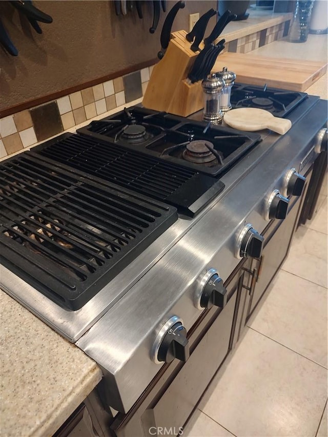 room details with stove and tasteful backsplash