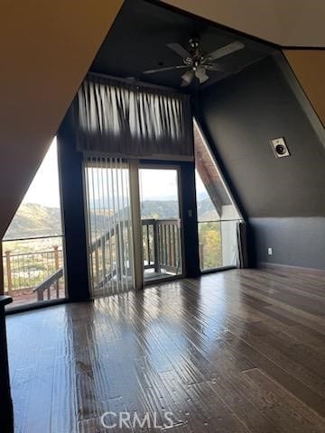 bonus room featuring wood finished floors and a ceiling fan