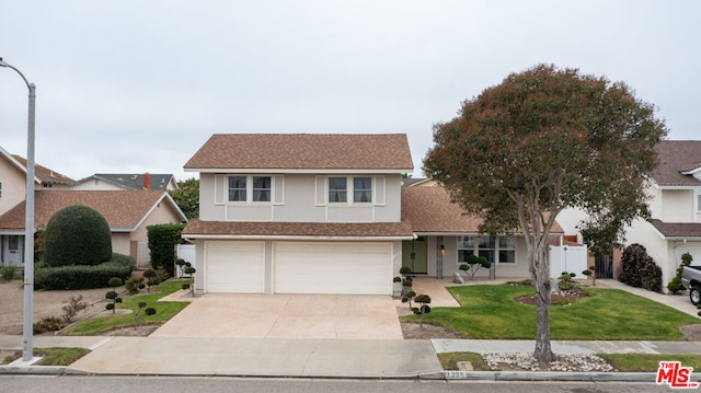 view of front of home featuring a garage and a front lawn