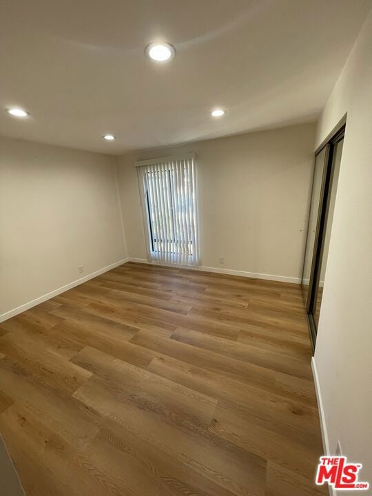 empty room with hardwood / wood-style floors