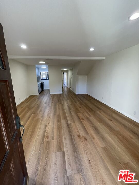 unfurnished living room with hardwood / wood-style flooring