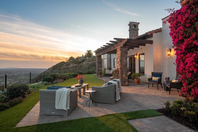 patio terrace at dusk featuring an outdoor living space, a lawn, and a pergola