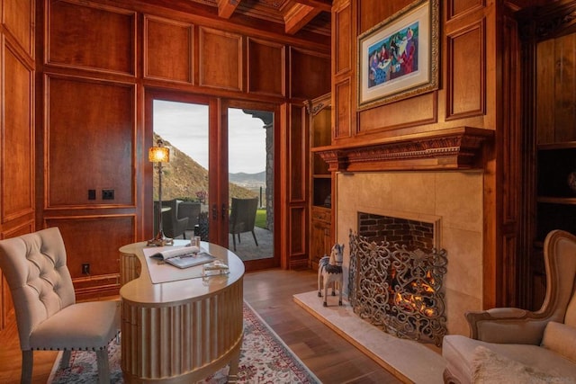 living area featuring coffered ceiling, beam ceiling, wood-type flooring, and wood walls