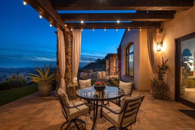 patio terrace at dusk featuring a pergola