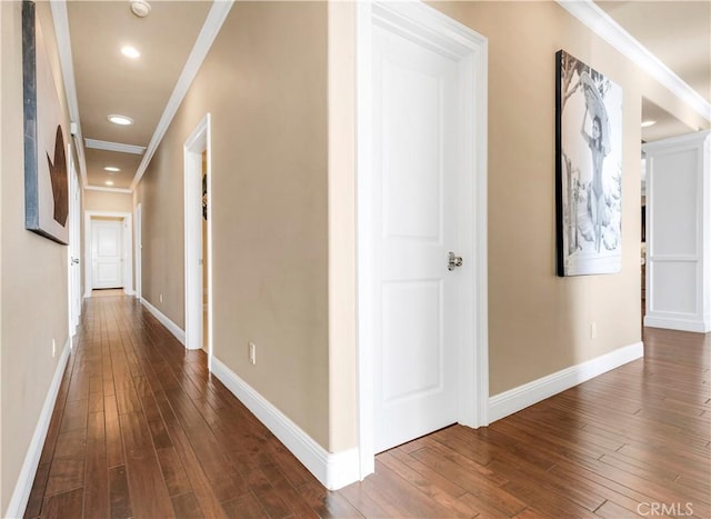 corridor featuring ornamental molding and dark hardwood / wood-style floors