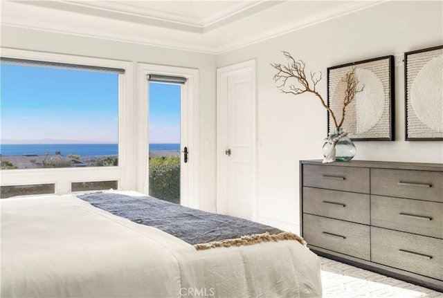 bedroom featuring a water view, ornamental molding, and multiple windows