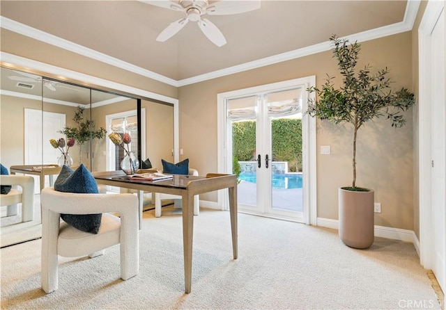 carpeted home office featuring french doors, ceiling fan, and ornamental molding