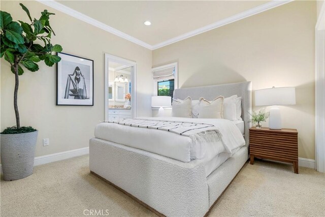 bedroom with crown molding, connected bathroom, and light carpet