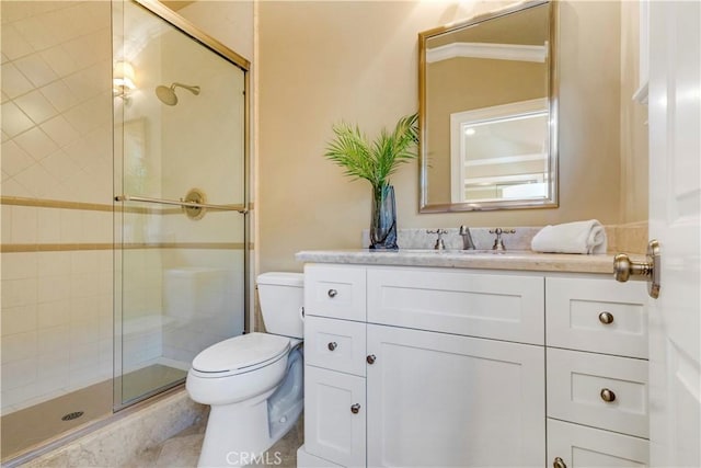 bathroom with vanity, a shower with shower door, and toilet