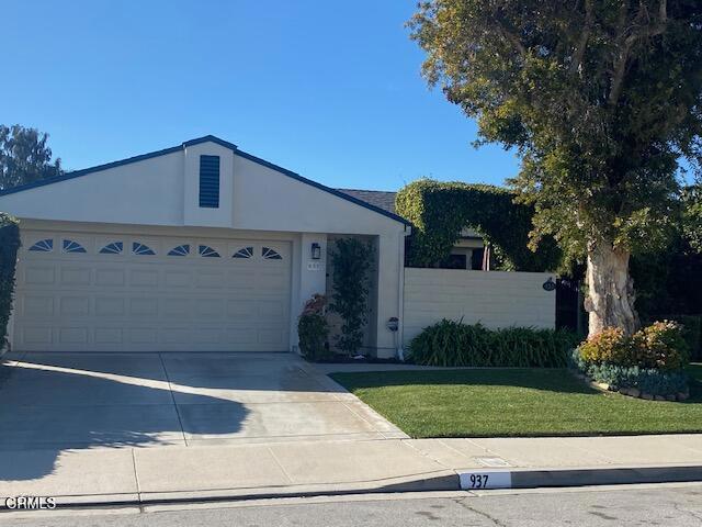 ranch-style home featuring a garage and a front yard