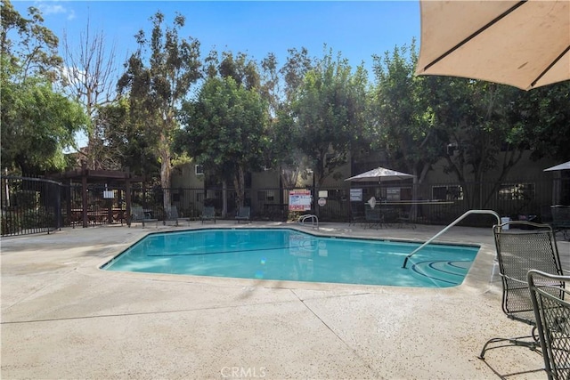 pool featuring a patio and fence