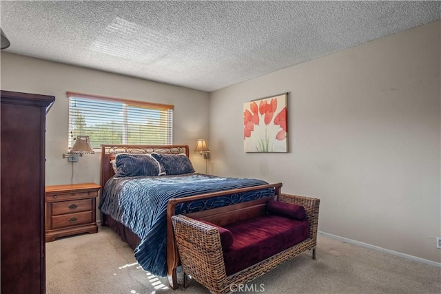 bedroom featuring baseboards, carpet floors, and a textured ceiling