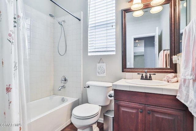 full bathroom with shower / tub combo with curtain, vanity, and toilet