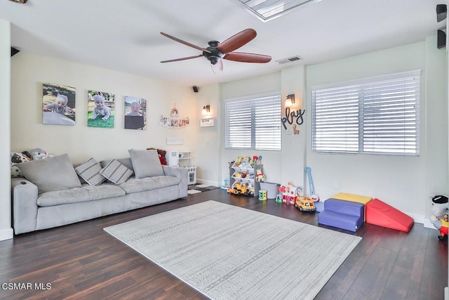 living room featuring dark hardwood / wood-style floors and ceiling fan