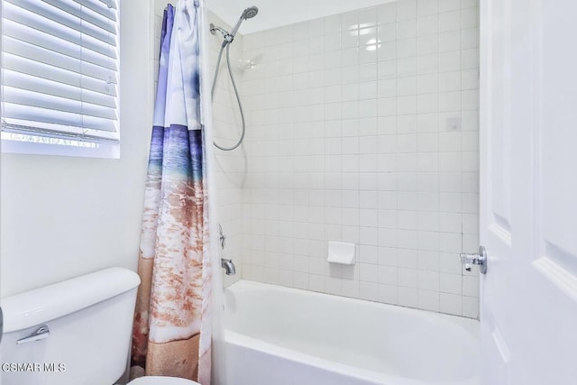 bathroom featuring shower / bathtub combination with curtain and toilet