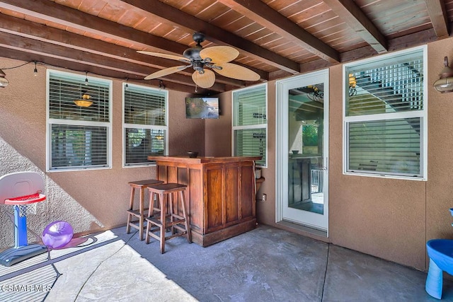 view of patio featuring an outdoor bar and ceiling fan