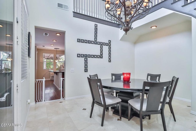 dining room featuring a towering ceiling