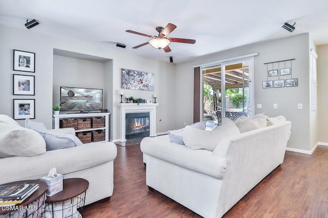 living room featuring dark hardwood / wood-style floors and ceiling fan