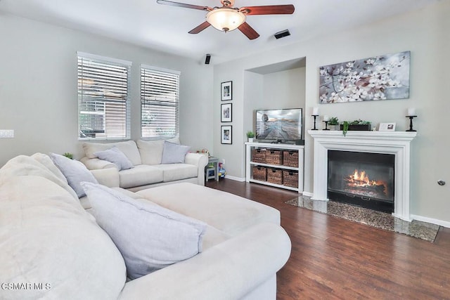 living room featuring ceiling fan and dark hardwood / wood-style flooring