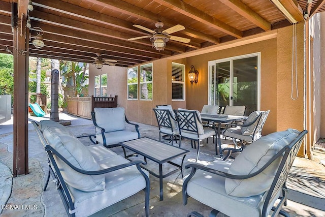 view of patio with ceiling fan and an outdoor living space