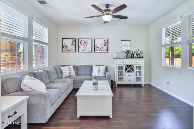 living room with dark wood-type flooring and ceiling fan