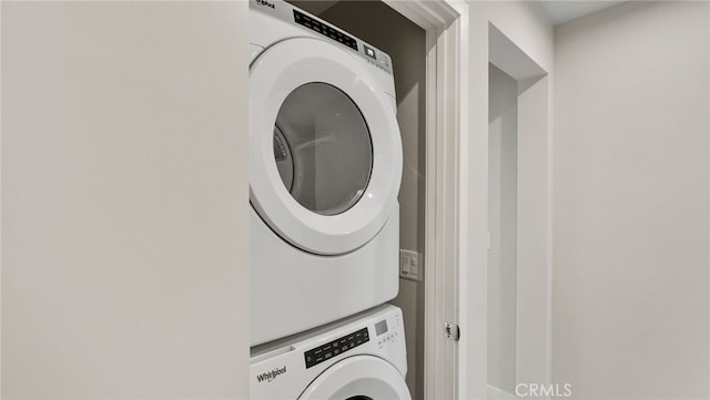 washroom with stacked washer and dryer