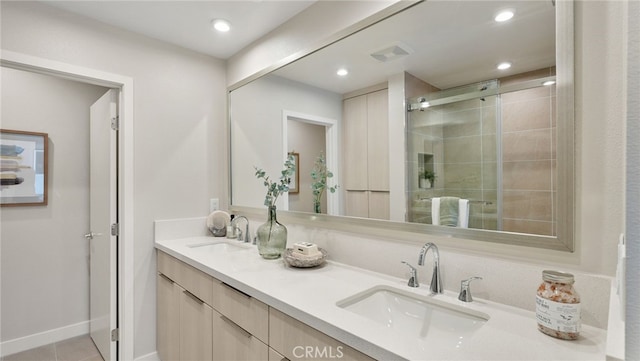 bathroom with vanity, tile patterned floors, and a shower with door