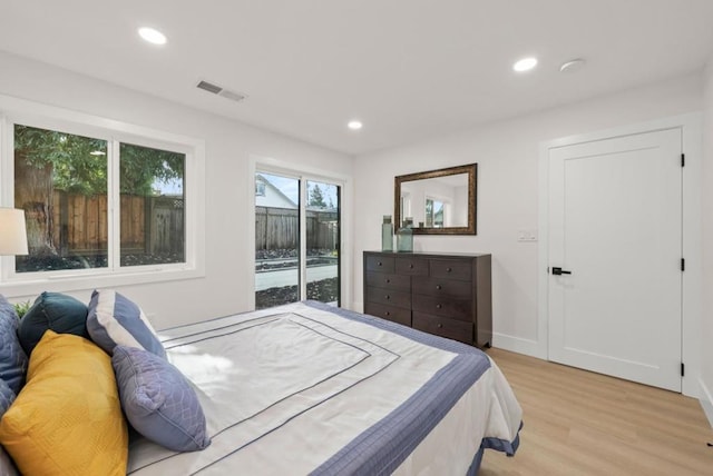 bedroom featuring access to exterior and light hardwood / wood-style floors