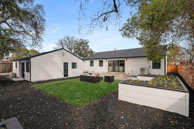 rear view of property with outdoor lounge area and a lawn