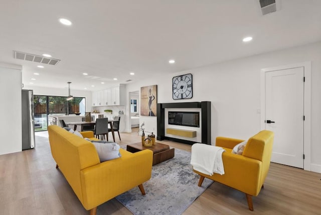 living room with sink and light hardwood / wood-style flooring