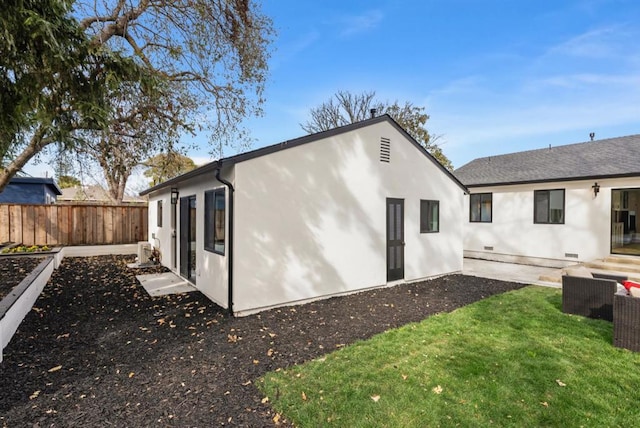 rear view of property featuring a yard and a patio area