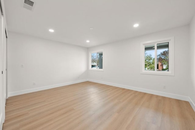 unfurnished room with a wealth of natural light and light hardwood / wood-style floors